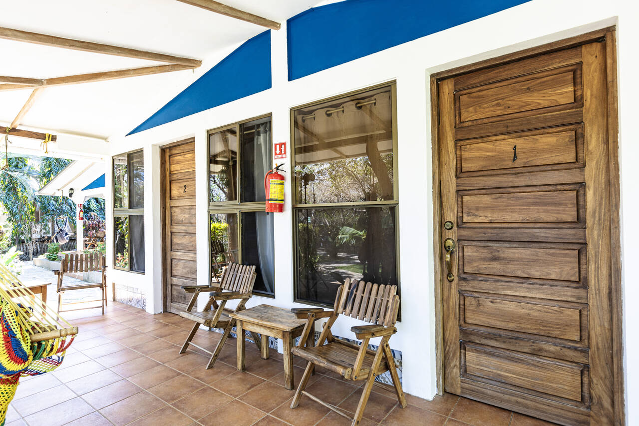 Front porch overlooks gardens and includes a hammo